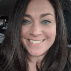 Smiling woman with long, dark hair and bright blue eyes. Close-up shot capturing a friendly and approachable expression.