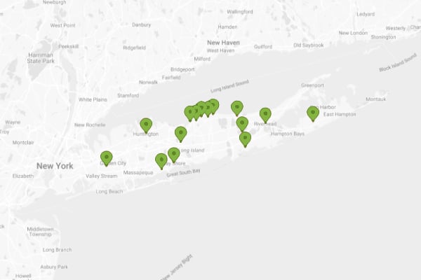 Map of Long Island, New York, dotted with green markers indicating Christmas lighting service locations. The map spans from near New York City to the Hamptons.