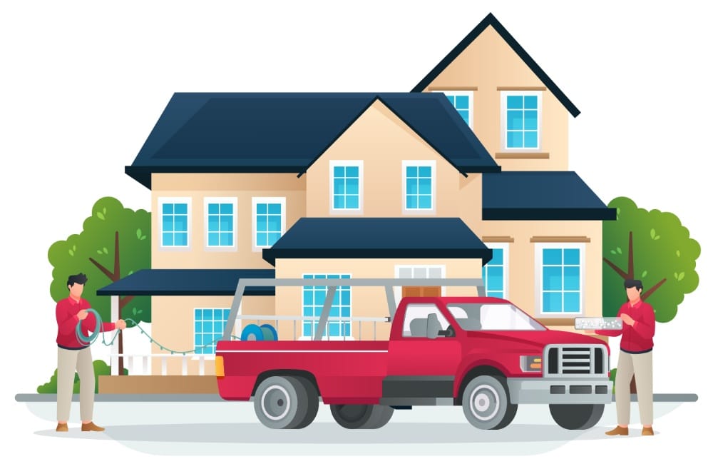 Two men install Christmas lighting on a beige two-story house. A red pickup truck is parked in front, loaded with supplies. Trees and a white picket fence add to the festive scene.
