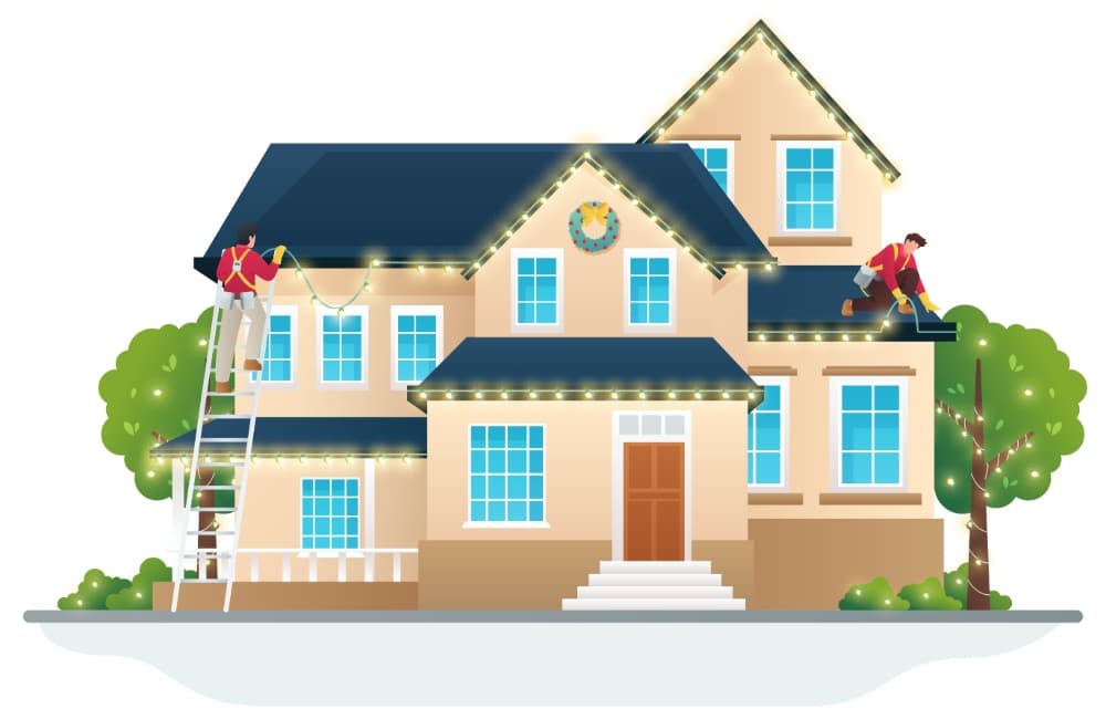 Two men install Christmas lighting on a tan two-story house with a blue roof. One man is on a ladder, the other on the roof. A wreath hangs above the front door. Trees and bushes surround the house.